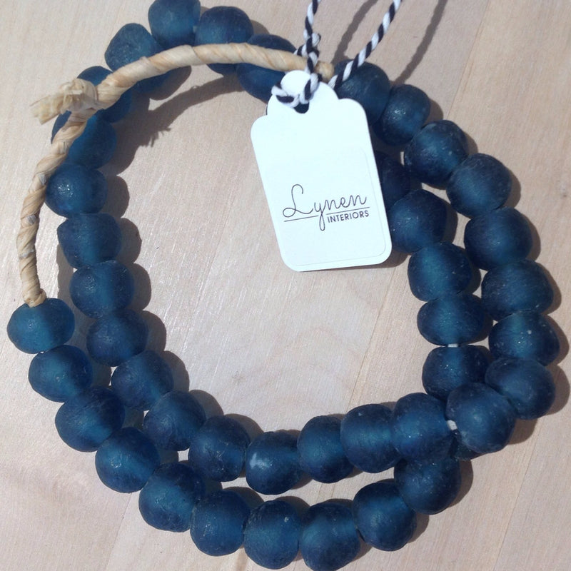 Hand made teal colored recycled beads by master artisans.